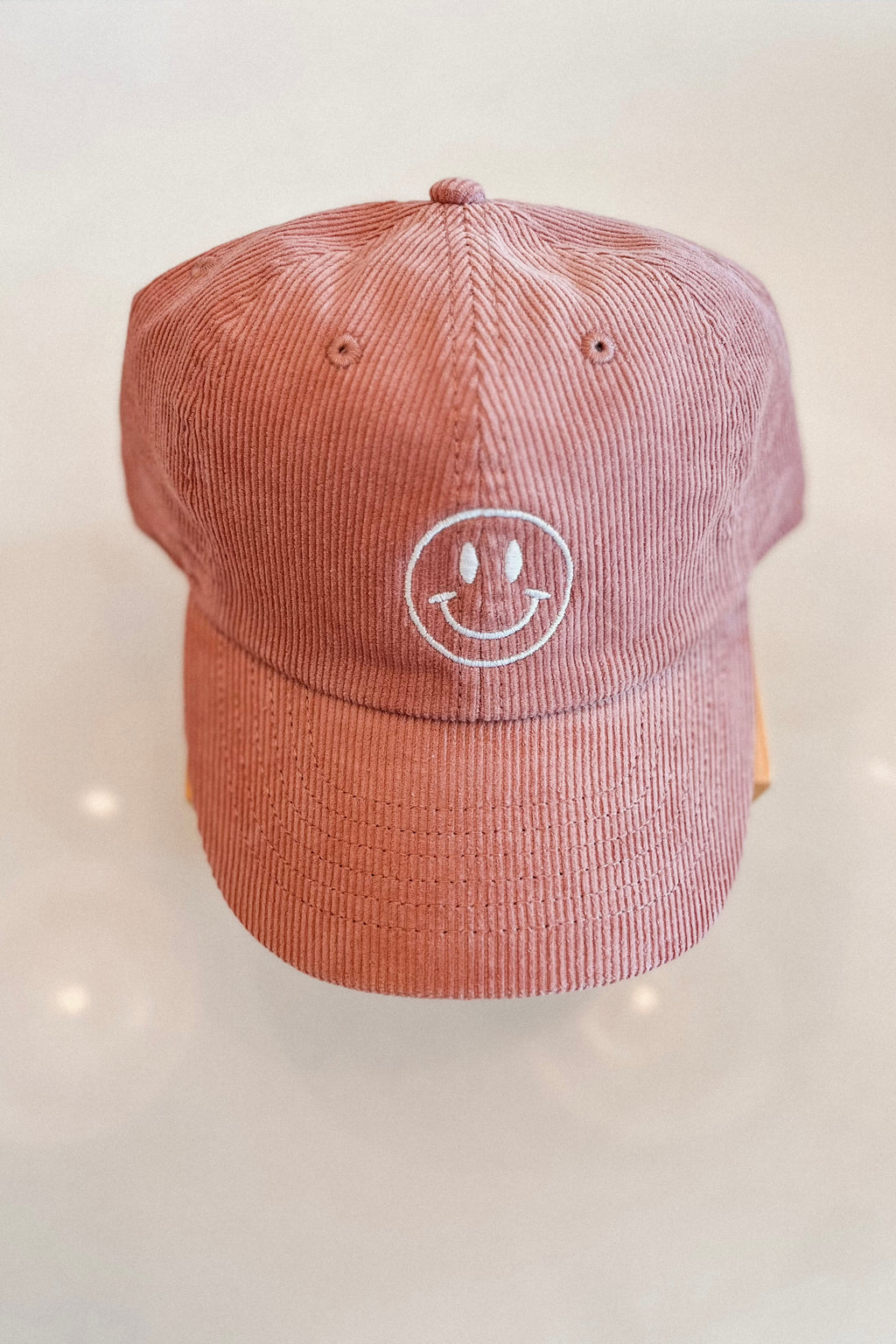 HAPPY FACE EMBROIDERED CORDUROY CAP MAUVE